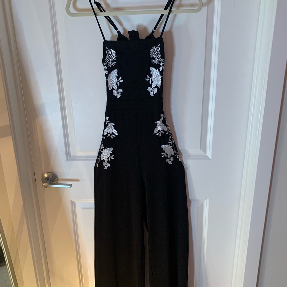 Form fitting spaghetti strap black romper w/ floral print & bow in back, Size S